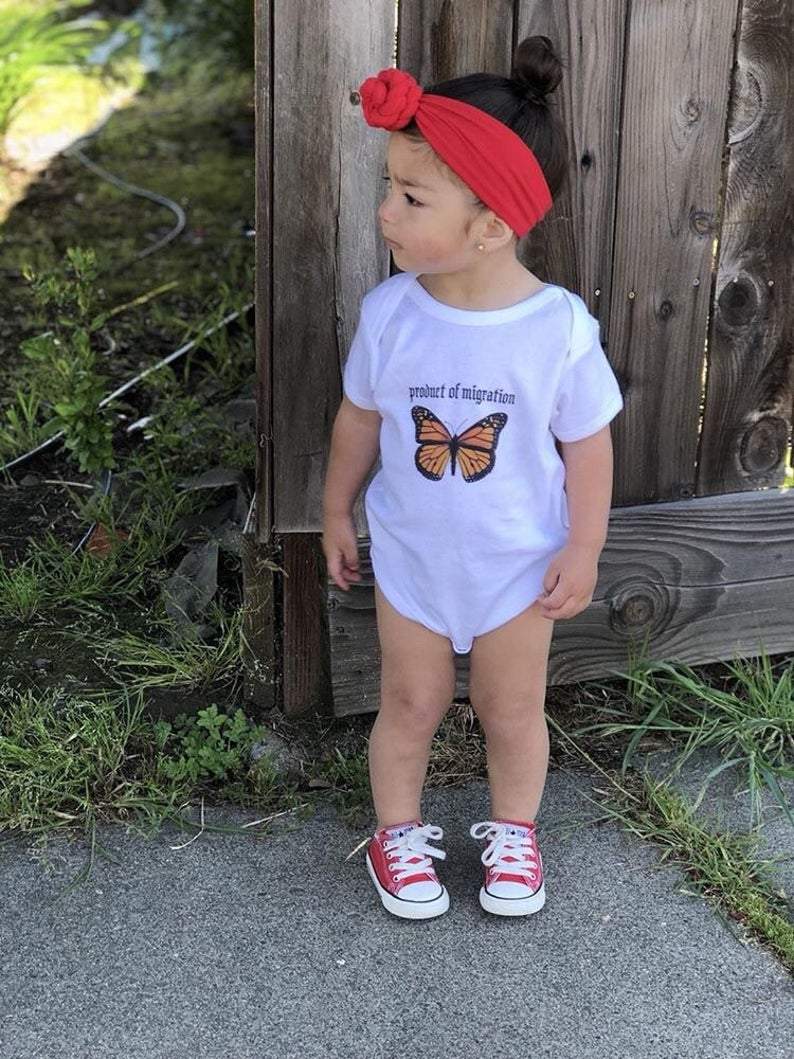 Product of Migration Onesie